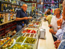 Customers seated at El Xampanyet restaurant's bar, Barcelona, Spain